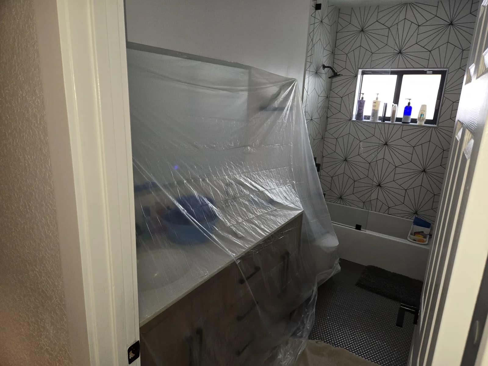 Bathroom vanity and nearby surfaces covered before duct service