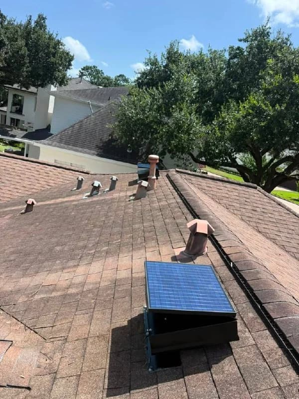 Solar attic fan installed on a residential shingle roof